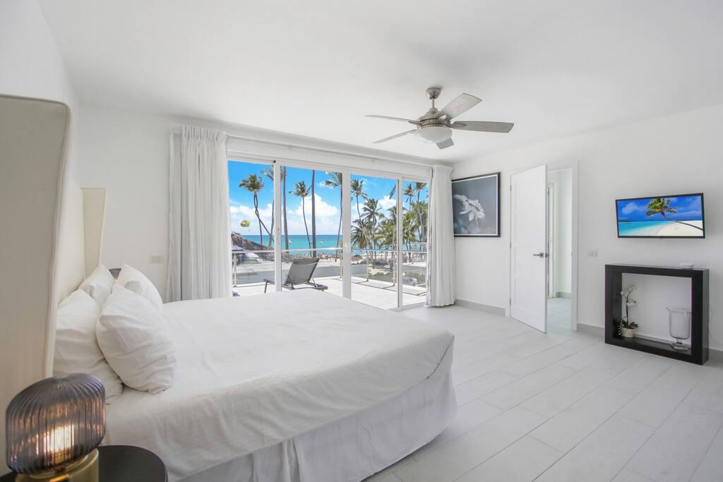 Primary bedroom 3rd floor with 1 King bed, balcony, ocean view, and ensuite bathroom