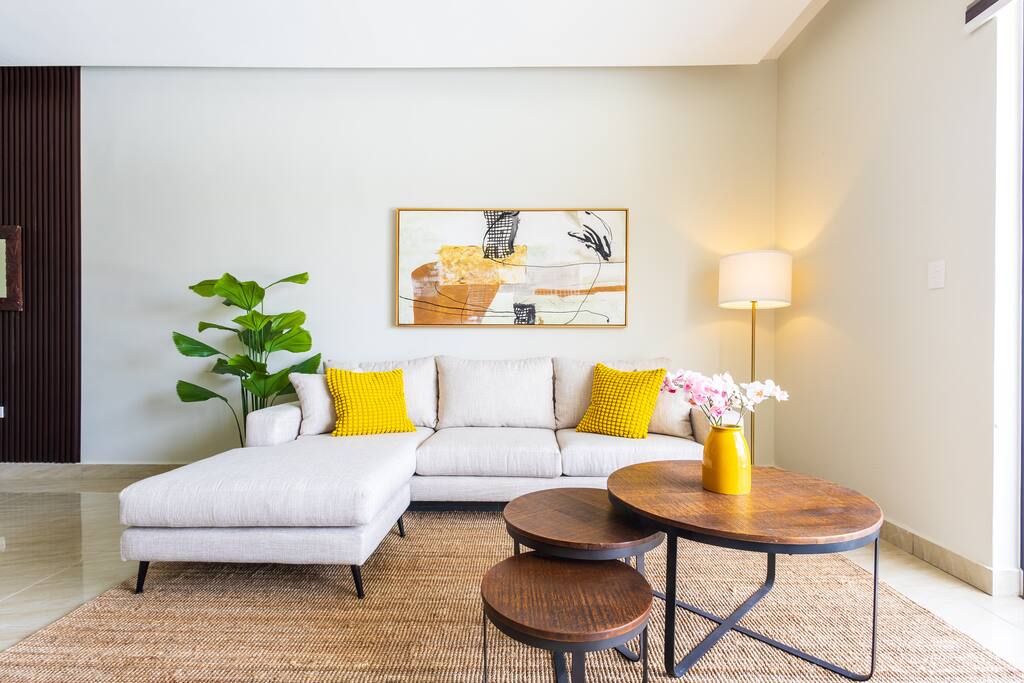 Bright open-plan living room with modern décor and natural light.