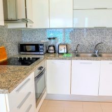 Airbnb Verified photo. White and shiny kitchen perfectly fits the whole beautiful design of this apartment. You can cook your favorite dishes here - it's a full-equipped, spacious kitchen