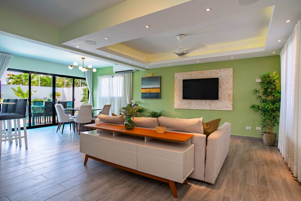 Modern lounge area with open layout flowing into dining and outdoor space.