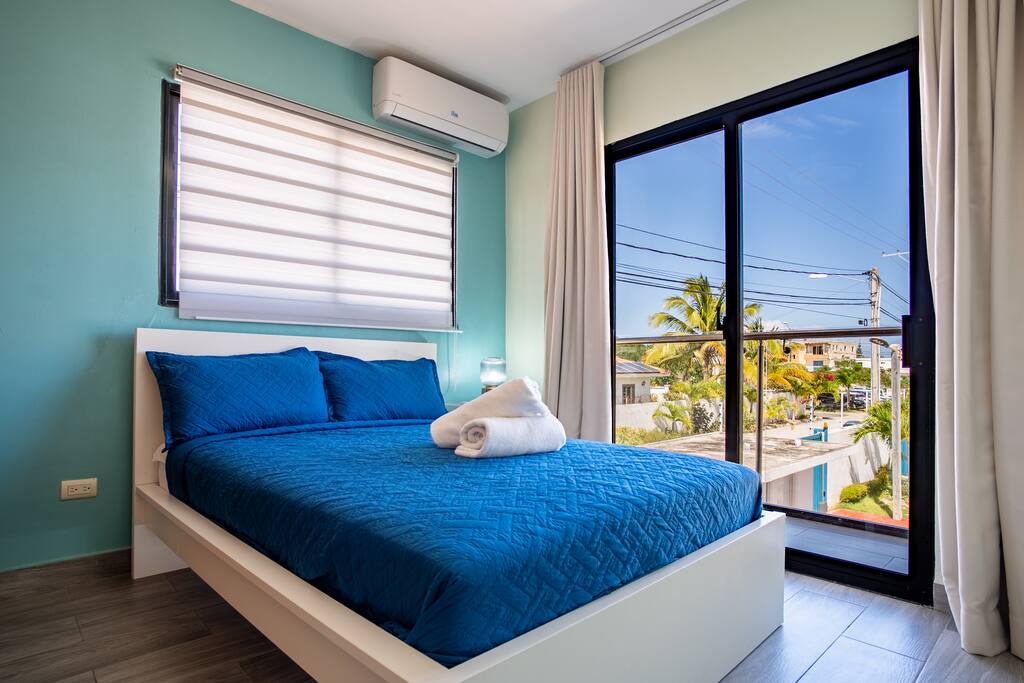 Comfortable double bedroom with balcony access and plenty of natural light.