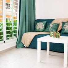 This cozy sofa near the window is perfect for a rest or reading books.