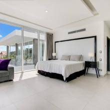 Villa Palma: Primary bedroom upstairs with King bed, desk and chair, TV, balcony, and ensuite bathroom
