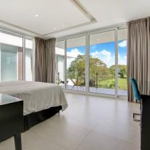 Villa Palma: Bedroom 3 - The 2nd primary bedroom with 1 King bed, air-conditioning, TV, desk and chair, closet, ensuite bathroom with double shower, and balcony with pool- and golf views