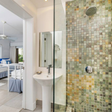 Small shower and washbasin in one of the bedrooms.
