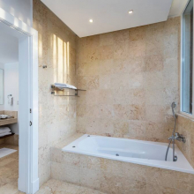 The spacious and bright bathroom has one overlooking the garden around the villa.