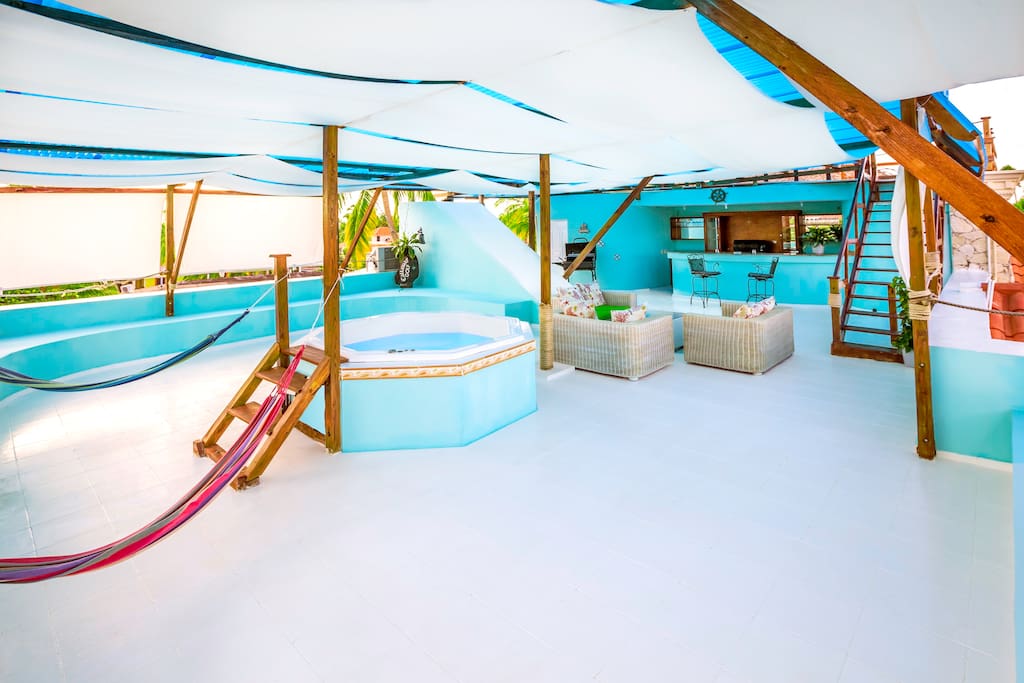 Your private second level has a spa, bar, full bathroom, laundry and a lot of open air and breathtaking views. It is perfect to host parties or accommodate a large group of visitors. It's cabana-style so you don't get too much sun