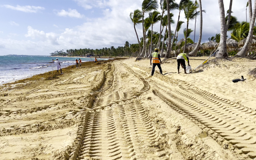 Workers clean up the algae on Sirenis Beach, Punta Cana