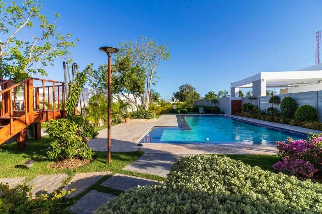 Large and clean swimming pool surrounded by greenery