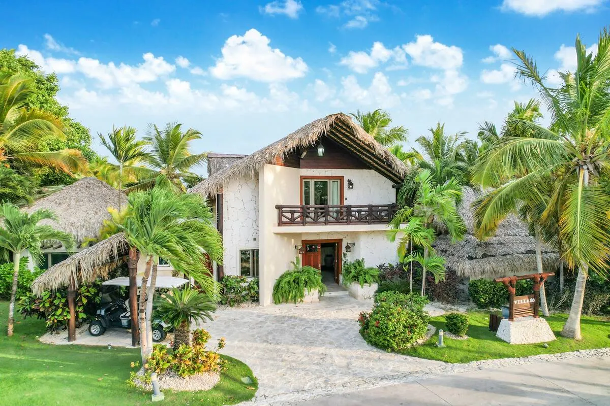 There are a lot of plants and trees around the villa