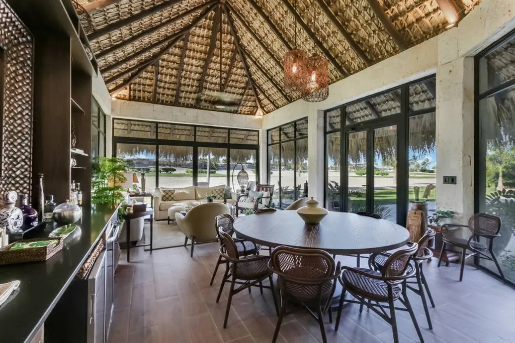 The dining room has large windows overlooking the pool and golf course